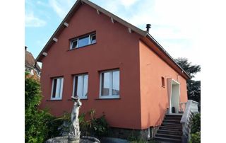 maison peinte en rouge avec fontaine